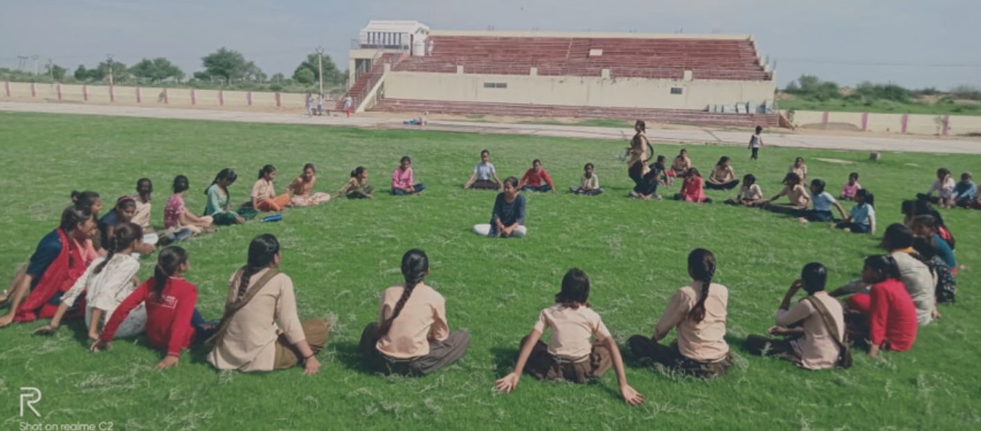 People sitting in a stadium field