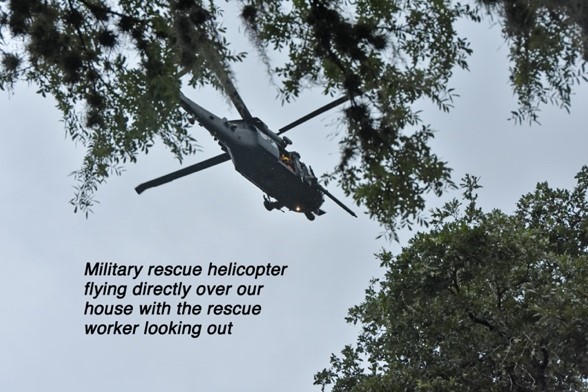 "Military rescue helicopter flying directly over our house with the rescue worker looking out"
