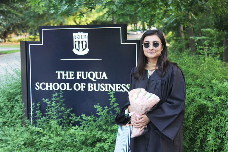 Rohma Zubair in front of Fuqua sign