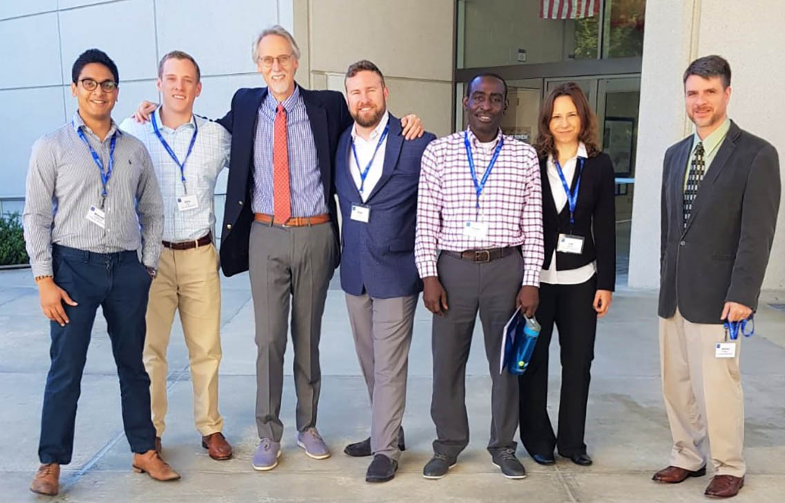 Photo of Weekend Executive MBA student Mukund Gourishankar with Dean Bill Boulding and fellow students