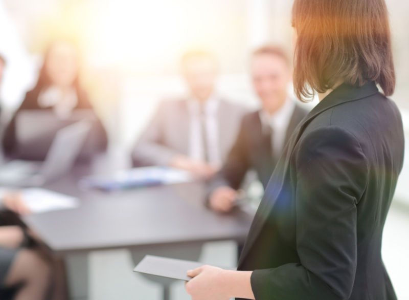 executive giving presentation at meeting