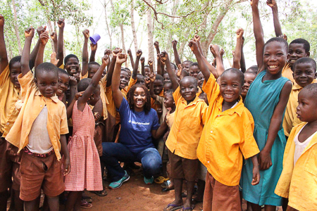 Carol Williams cheering with group of children