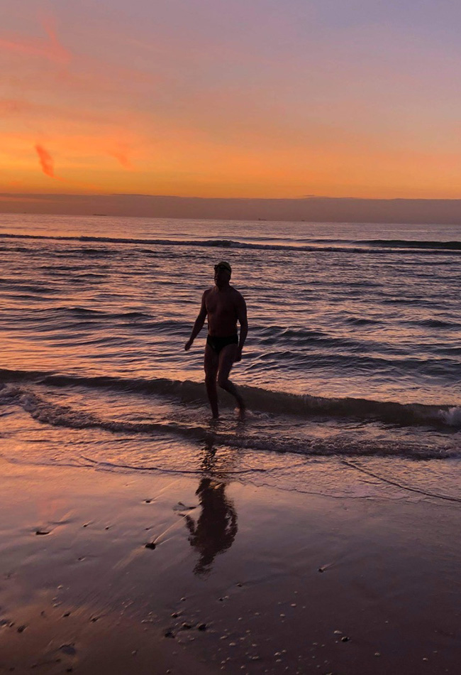 Erwan Le Roy walking on beach