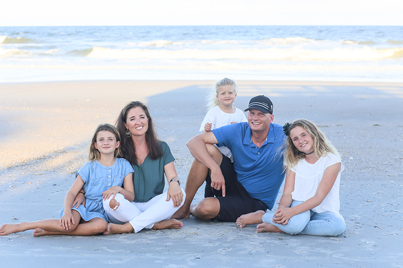 Kelly Dyer and family sitting on beach