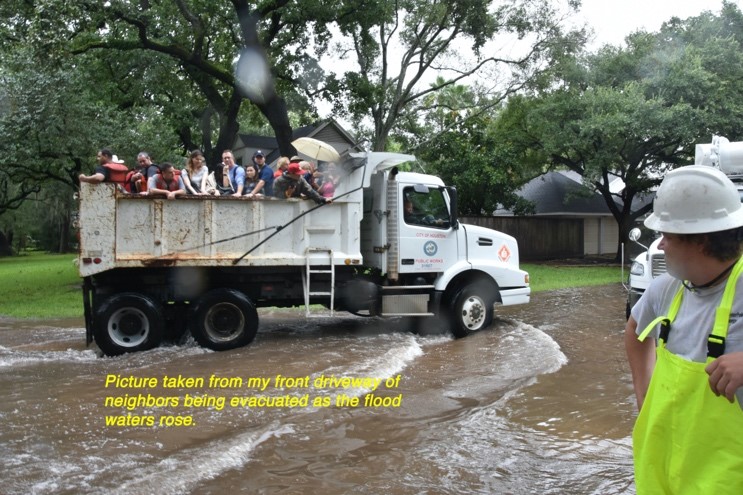 "Picture taken from my front driveway of neighbors being evacuated as the flood waters rose."