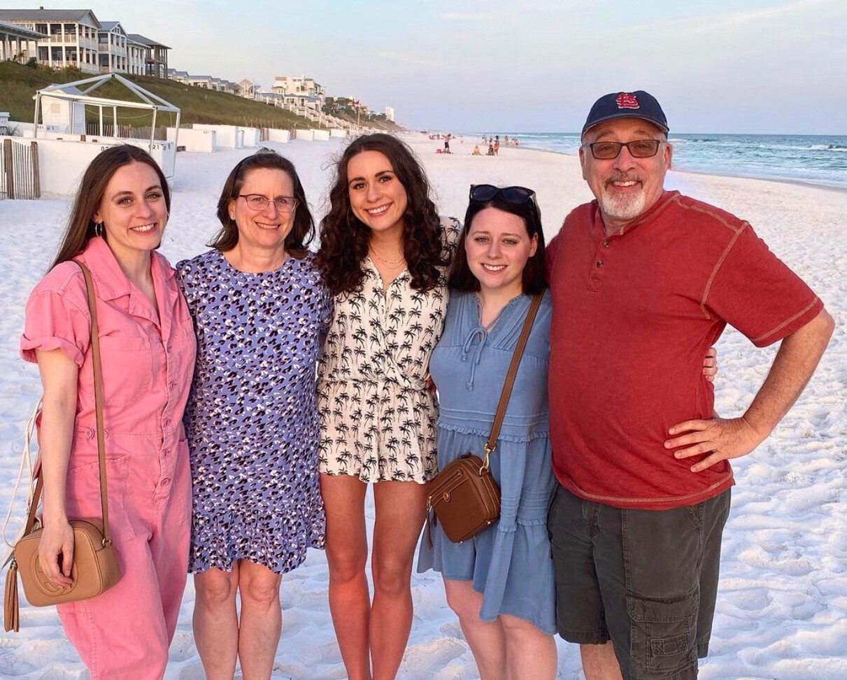 Charles and his family enjoy a walk on the beach at sunset.
