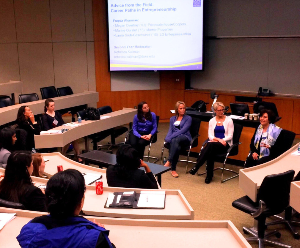 Laura and other alumna members speak to Fuqua students in a classroom.